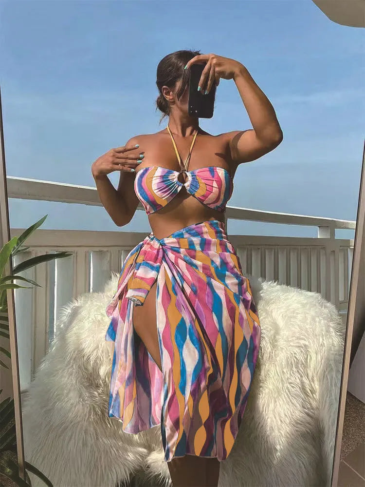 Women's three-piece printed swimsuit set with beach skirt in magenta colour