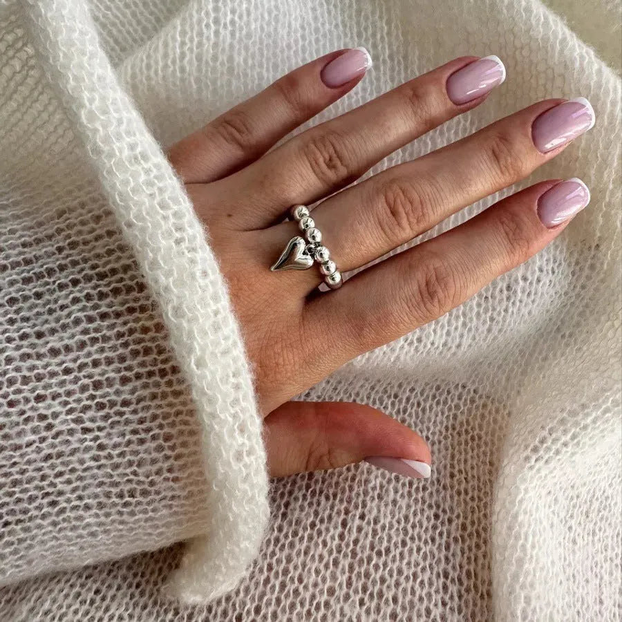 Handmade elastic beaded love ring with geometric heart design in gold and white electroplated finishes