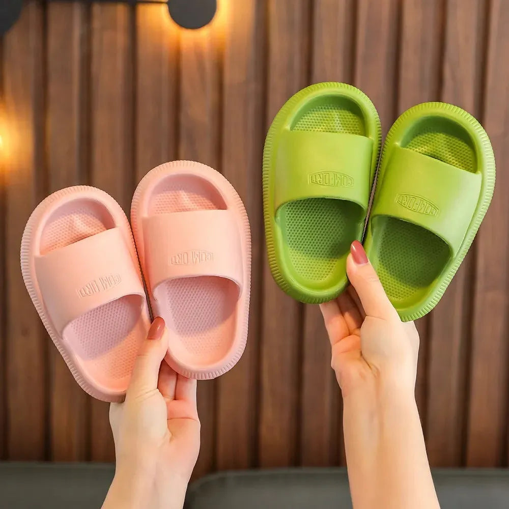 Children's mixed colour EVA slippers with textured non-slip soles and 1.5cm thick cushioning.
