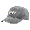 Retro beige peaked cap with embroidered letters, showing distressed fabric texture and adjustable strap.