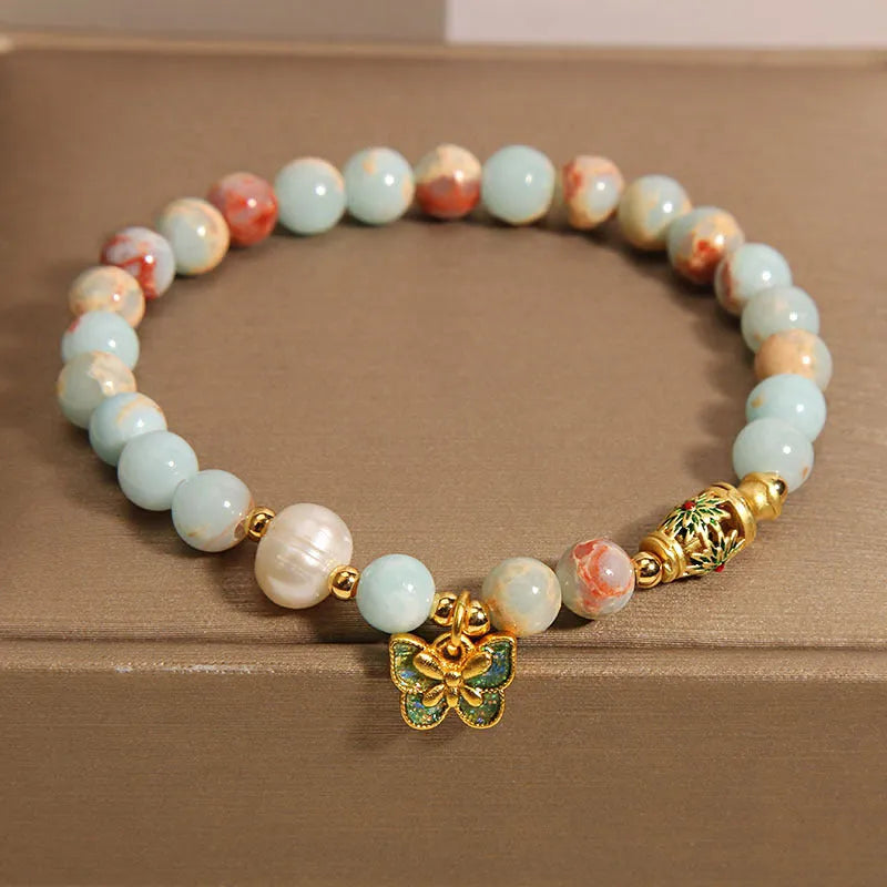 Blue women's bracelet with Shoushan stone, freshwater pearls and butterfly charm pendant