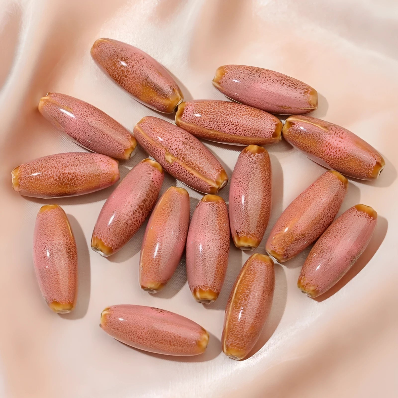 Assorted high-temperature fired ceramic bullet beads in pink, yellow, blue, red, coffee, green, orange, and mixed glaze colours.