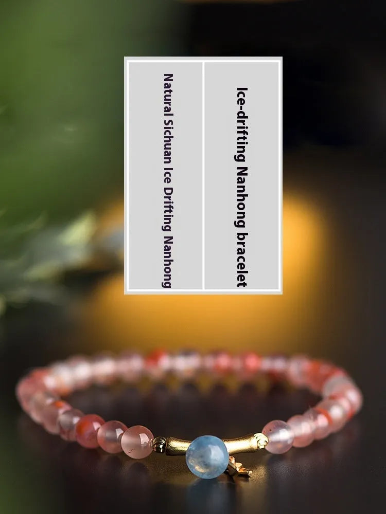 Polished Nanhong agate bracelet with ethnic bamboo-joint and flower design on a wrist.