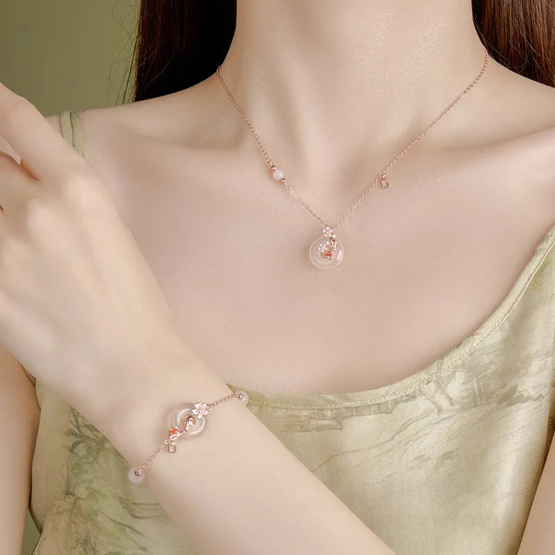 Women's S925 sterling silver bracelet with white chalcedony crystals and electroplated koi fish design.