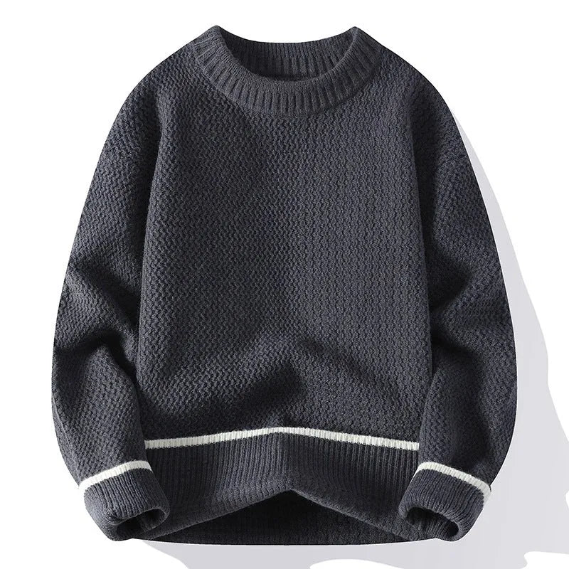 Man wearing a grey loose-fit round neck knitwear pullover sweater for casual autumn wear.