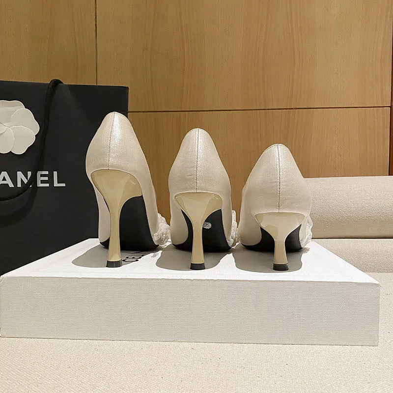 Women's stiletto heels in champagne colour with satin upper, pointed toe, and decorative lace and beading