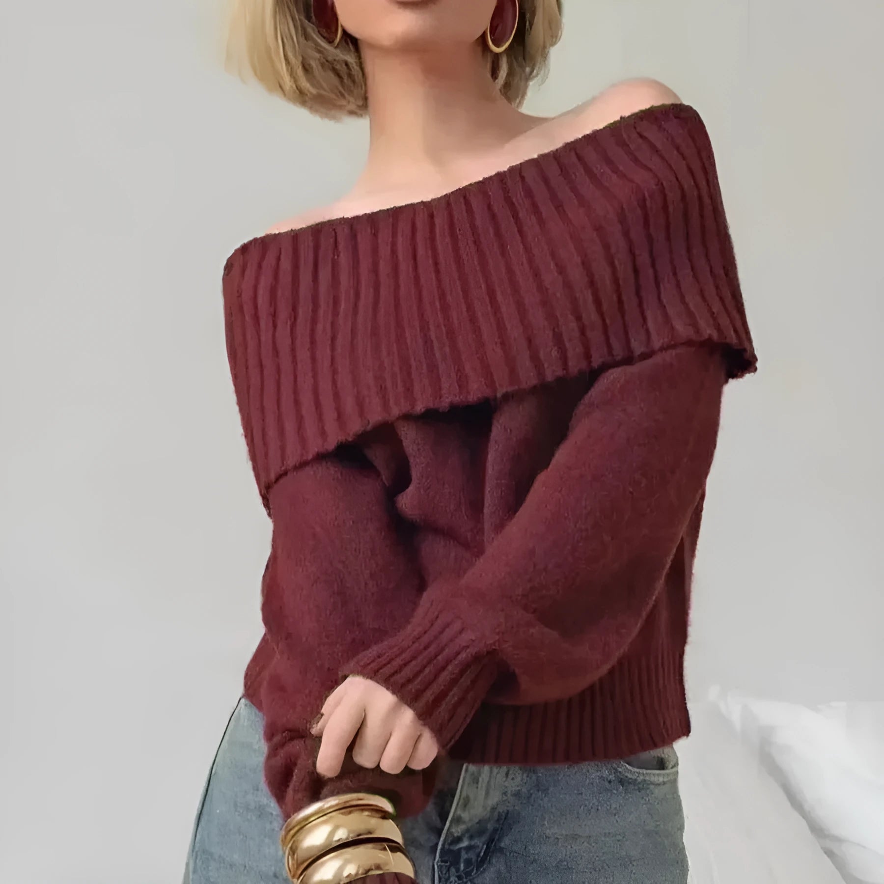 Grey off-the-shoulder sweater with a 3D pattern and strapless design on a model.