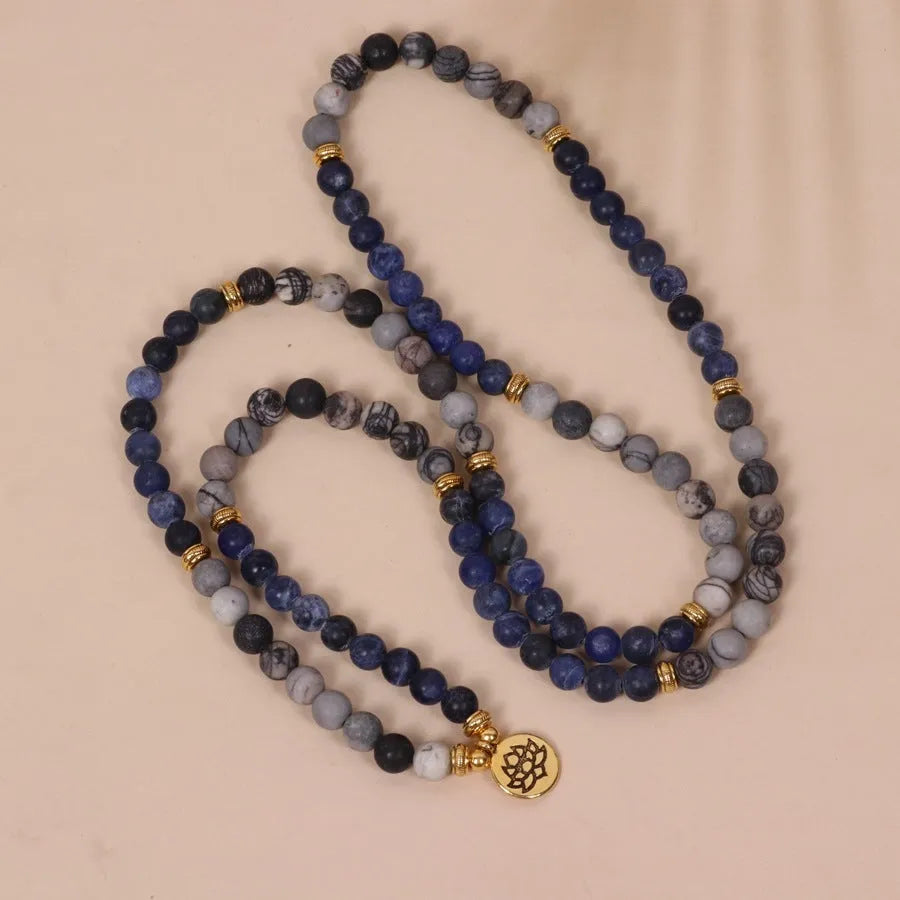 Blue multi-layer bracelet with patterned network stone beads on an alloy base.
