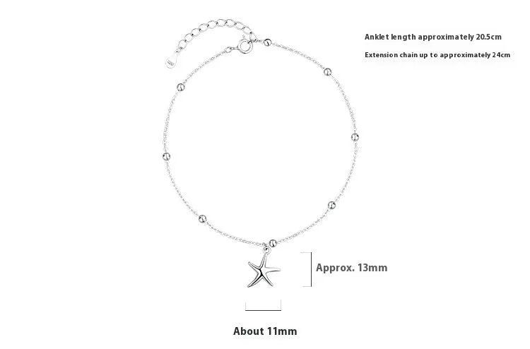 Close-up of a sterling silver anklet with a small starfish charm on a chain of tiny round beads.