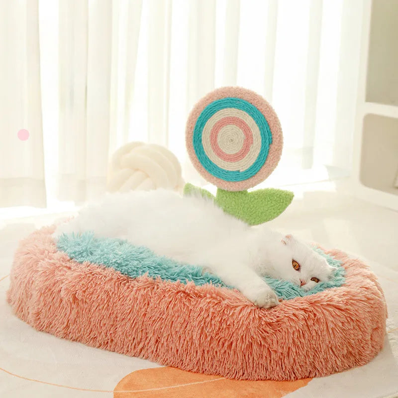 Pink thick plush elliptical cat bed with a deep, lollipop-shaped nest for cats.