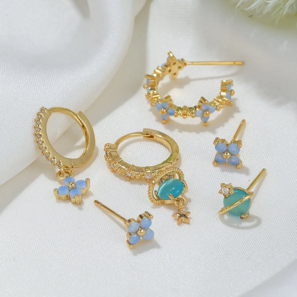 Gold and silver floral ear studs with zircon mosaic details in Japanese Korean style.