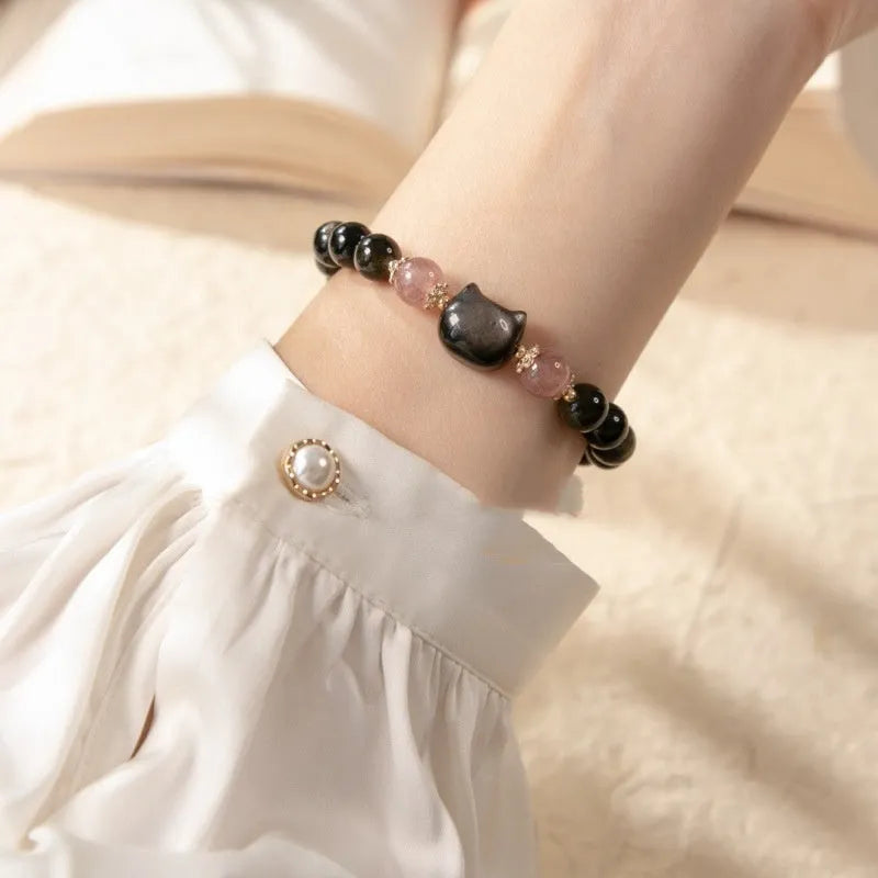 Black natural obsidian bead bracelet with a kitty charm on a stretch cord.