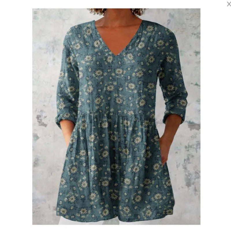 A loose-fitting women's dress with a wave print, 3/4 sleeves, and a wide waist.