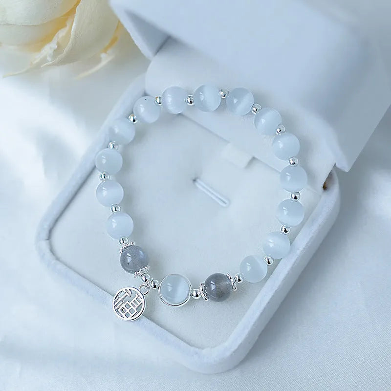 Close-up of electroplated opal cat's eye beaded bracelet for women with diamond-shaped charm