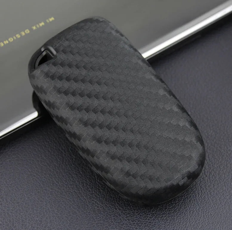 Black silicone key case for Dodge Chrysler Fiat remote, shown with and without a large plastic attachment buckle.