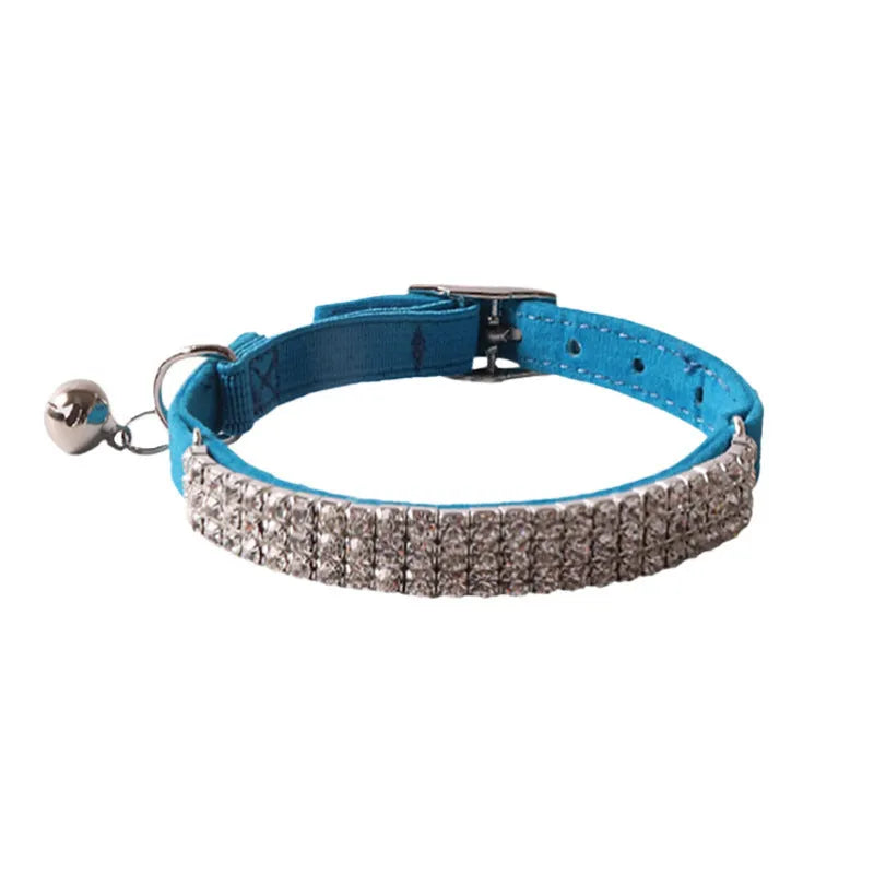 Elastic buckle cat collar in flocking fabric with gang drill detail, shown in multiple colours.