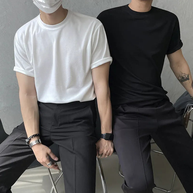 Men's slim fit cotton t-shirt in black with round neck and half sleeves on a model.