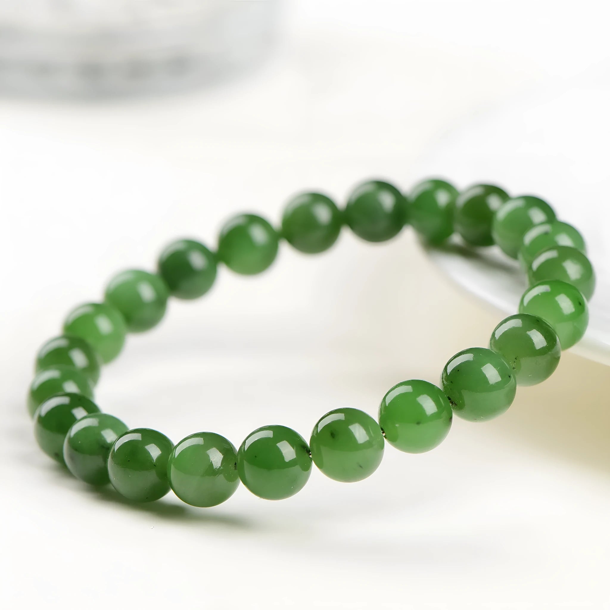 Natural Jasper bead bracelet with polished Russian Jasper beads in multiple sizes on a white background.