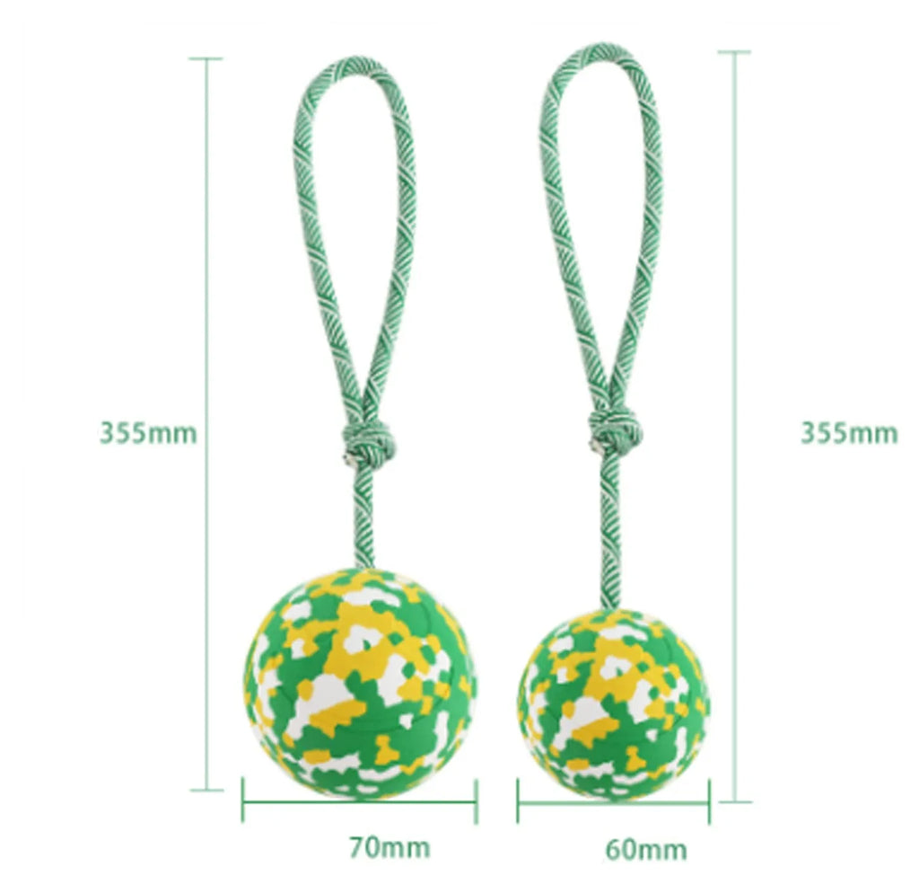 Natural rubber dog ball attached to a blue nylon rope for fetch and tug toys.