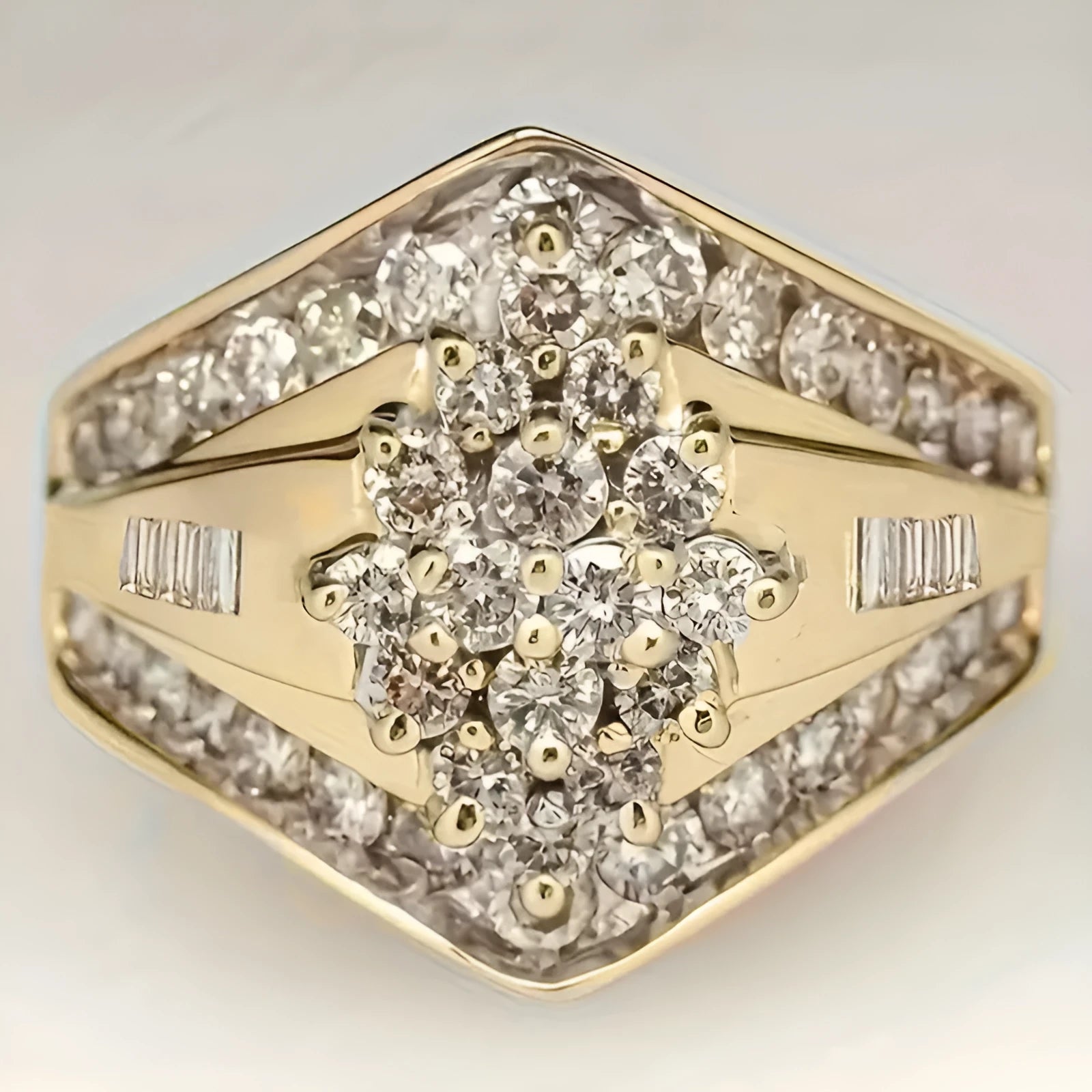 Geometric gold-coloured palace style fashion ring on a plain background, showing its angular design.
