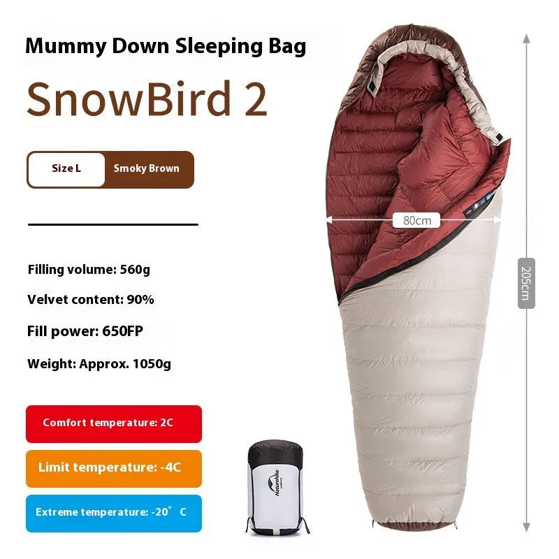 Blue and grey mummy-style down sleeping bag packed in its storage bag for camping.