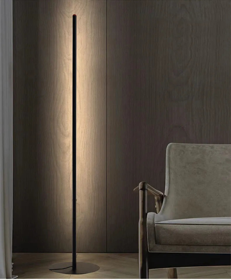 Vertical aluminium alloy floor lamp in modern simplicity style on a table.