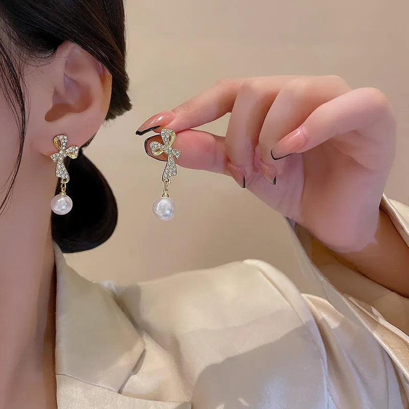 Gold alloy butterfly earrings with rhinestone accents and bow design for women