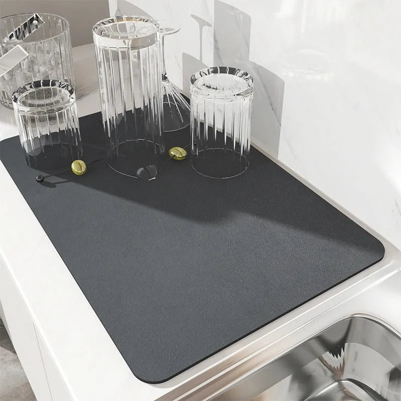 Black square absorbent drain pad mat with PU leather surface on a kitchen countertop