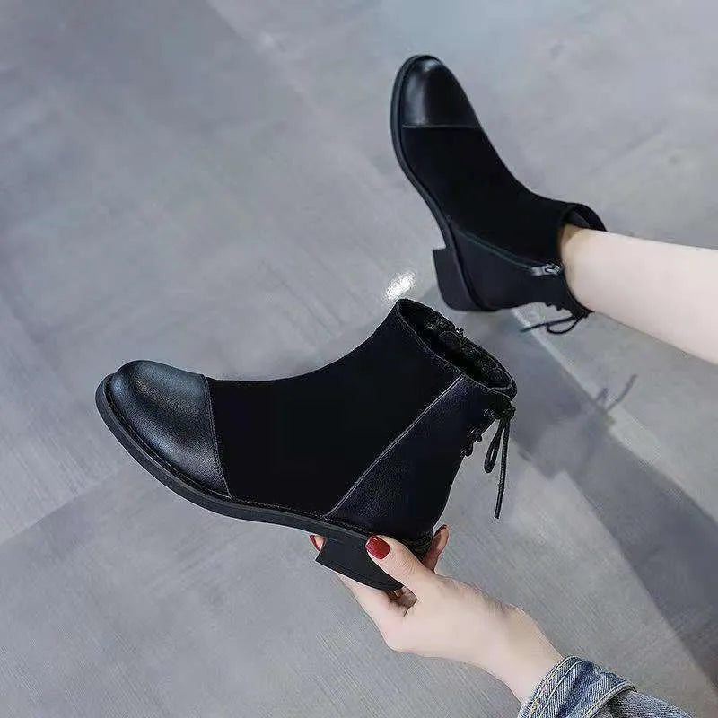 Black women's knee-high Martin boots with side zip and a decorative bow.