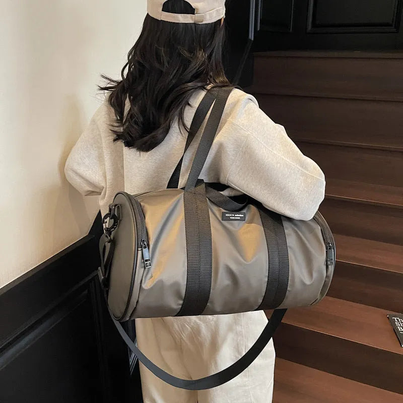 Black waterproof Oxford cloth sports handbag for men and women on a leisure travel background.