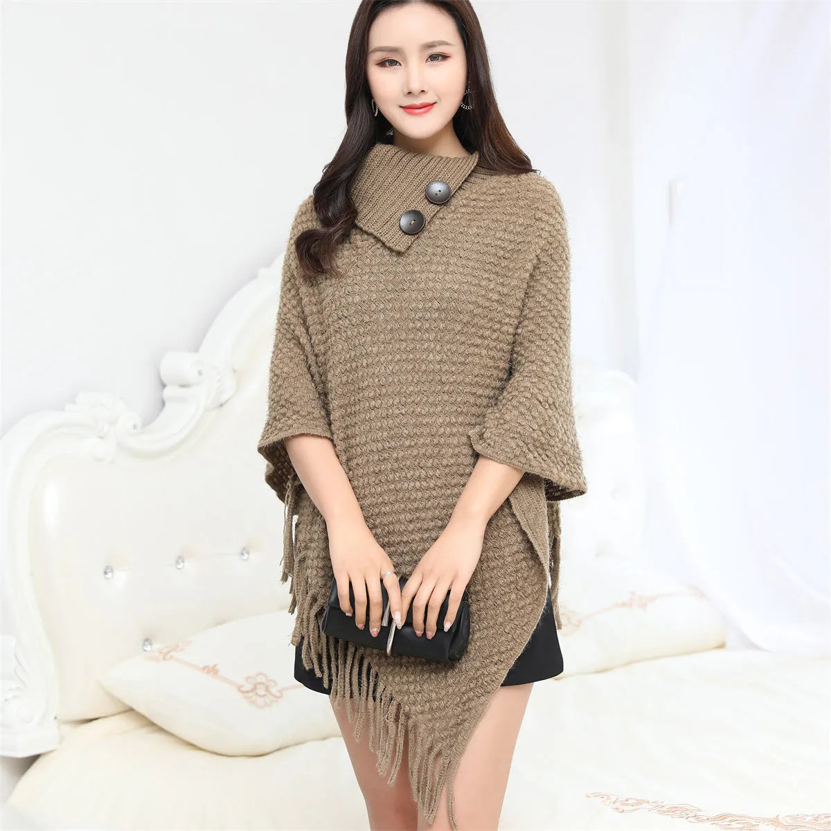 Women's dotted pattern sleeveless knit cloak shawl in acrylic fibre, shown in apricot colour.