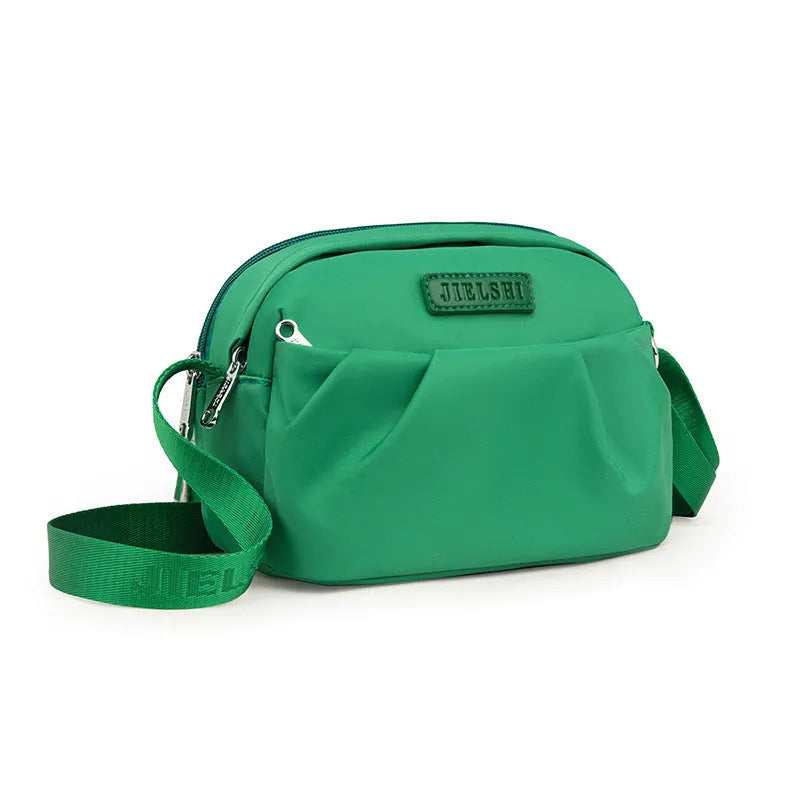Pleated Oxford cloth shoulder messenger bag in horizontal square shape with cross-body strap
