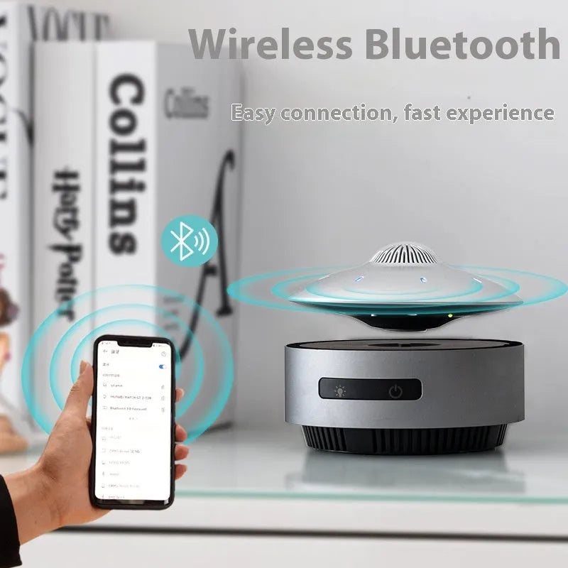 Black automatic lifting magnetic levitation Bluetooth speaker floating above its base.