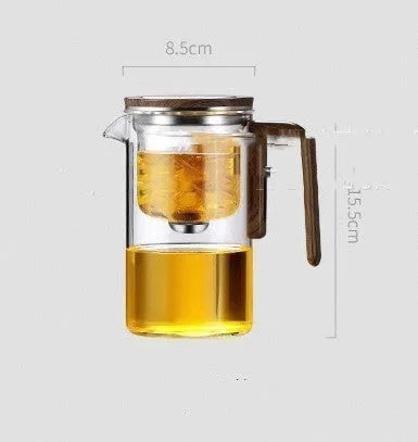 Glass teapot with wooden handle showing magnetic tea separation button and drip-free spout.