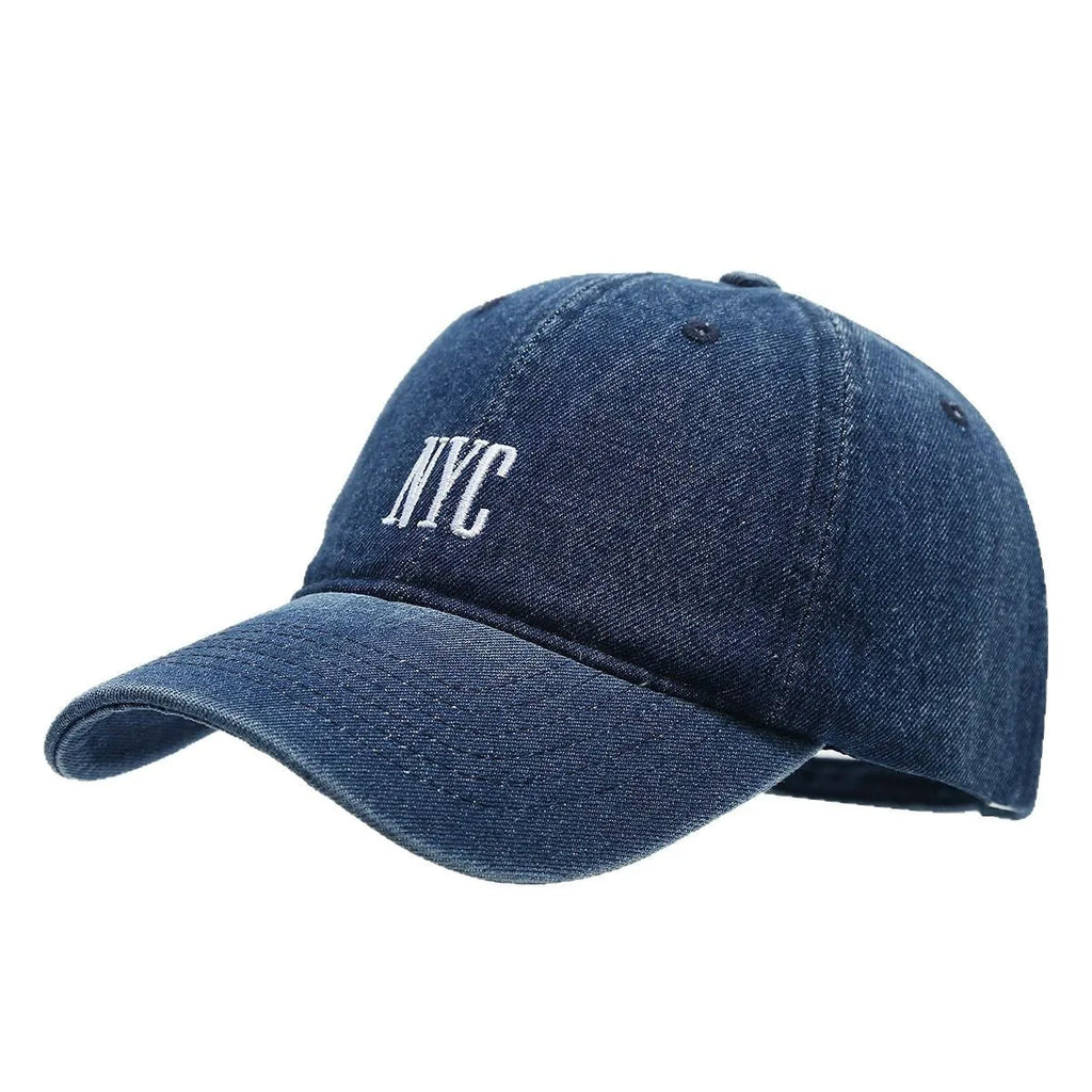 Adjustable denim peaked cap with a dome crown and a large English letter design on the front.