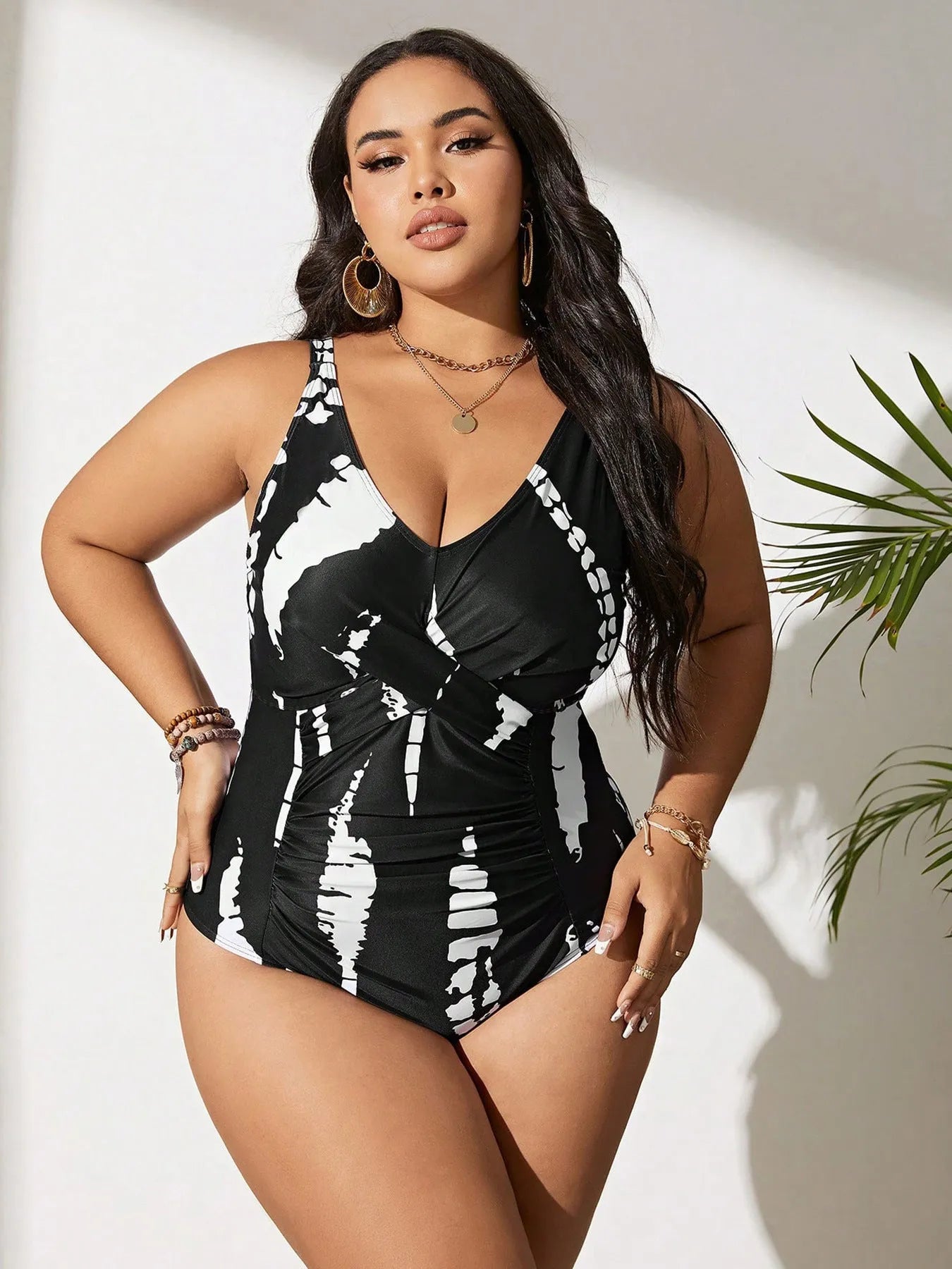 Black colour matching one-piece swimsuit with conservative cut and sleeveless design on mannequin