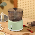 Mini electric meat grinder in white or light green with transparent 225ml cup and stainless steel blades