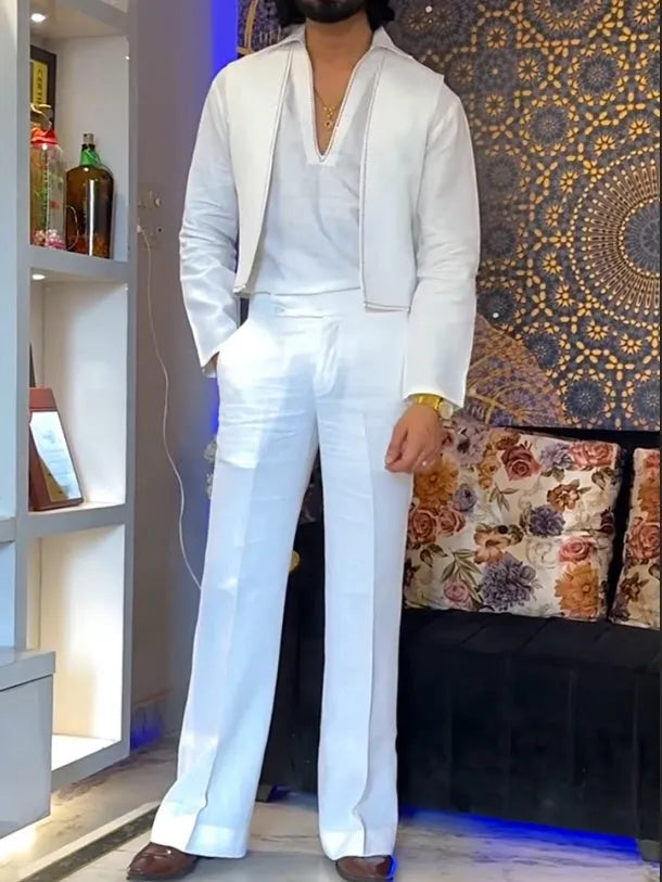 White three-piece outfit comprising V-neck shirt, sleeveless vest and trousers on hanger