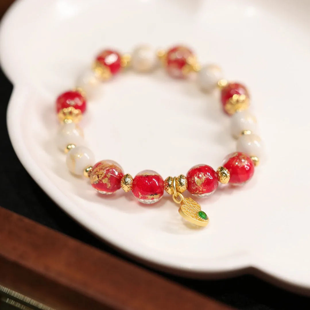 Handmade ethnic style coloured glaze bracelet with gold foil detailing and porcelain hanging gourd design