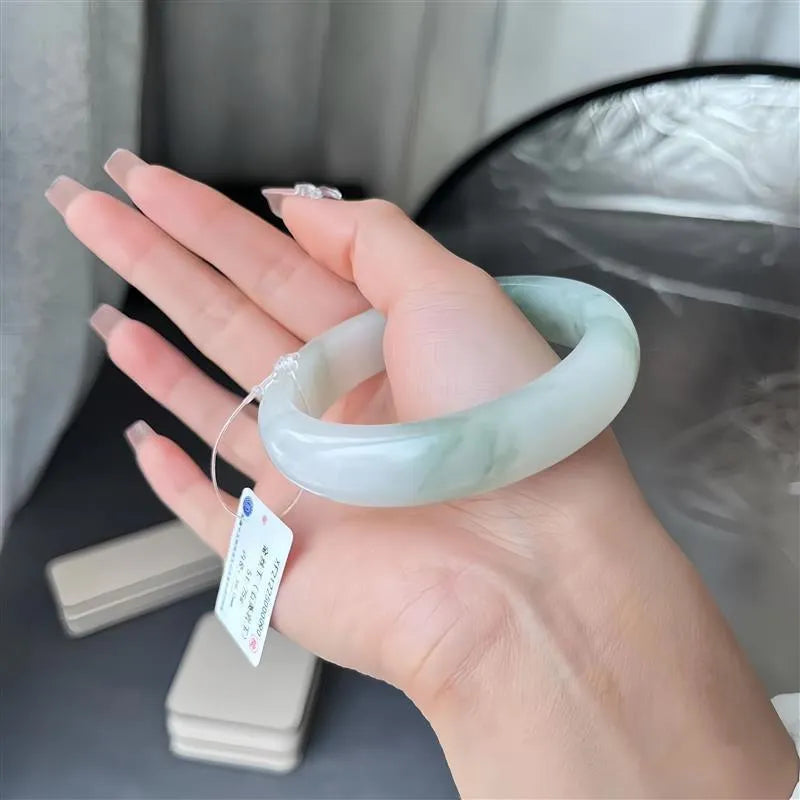 Tian Shan Cui jade bracelet with ice-like floral pattern and adjustable 52mm-64mm sizing.