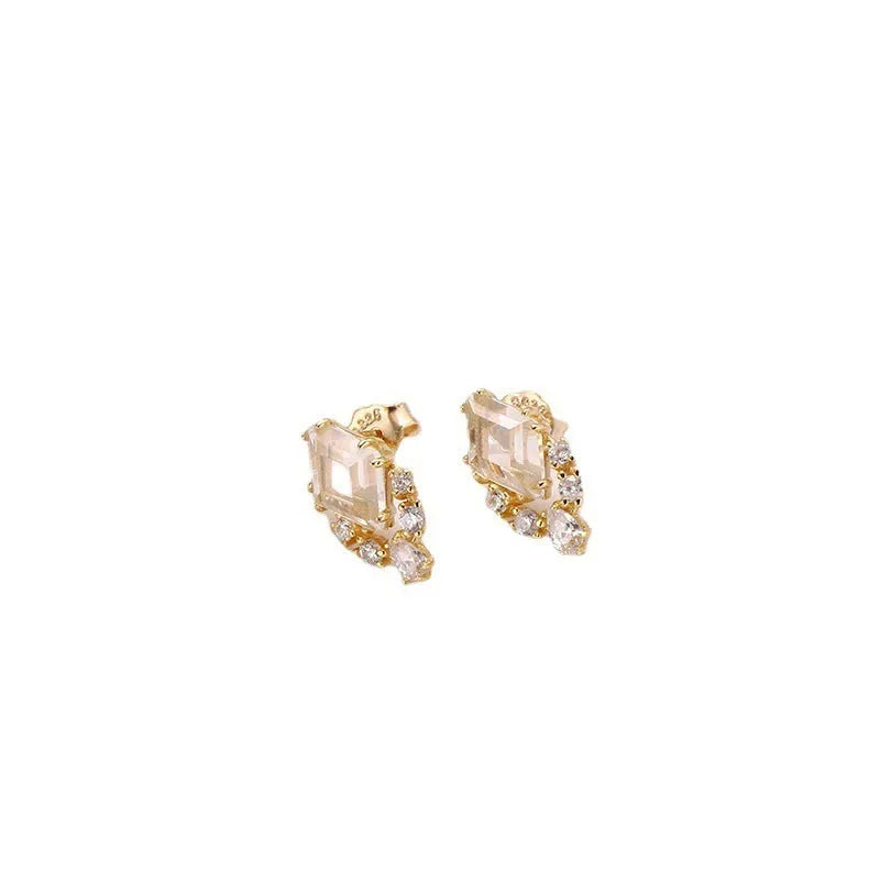 Geometric silver earrings with white crystal studs showing front detail