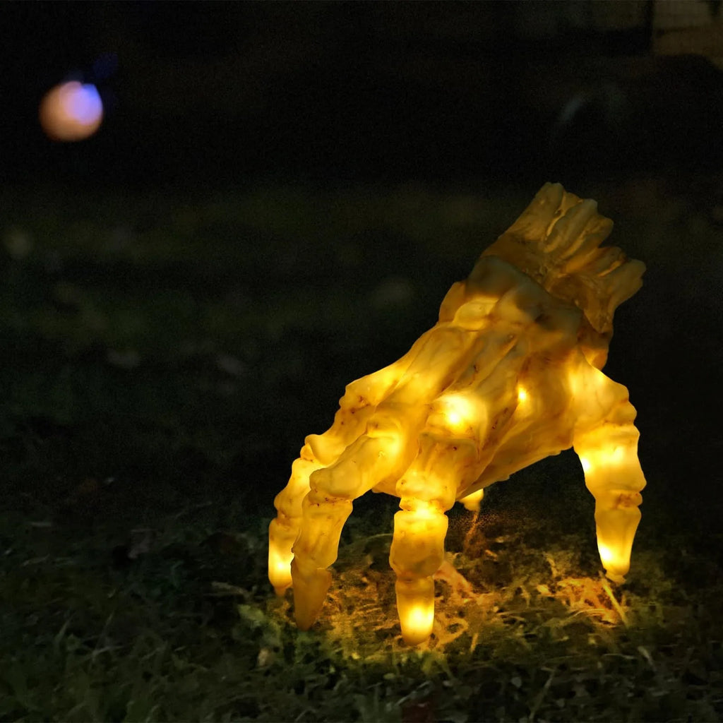Halloween electric luminous crawling hand on floor, glowing warm colour, vinyl zombie hand with spooky sound