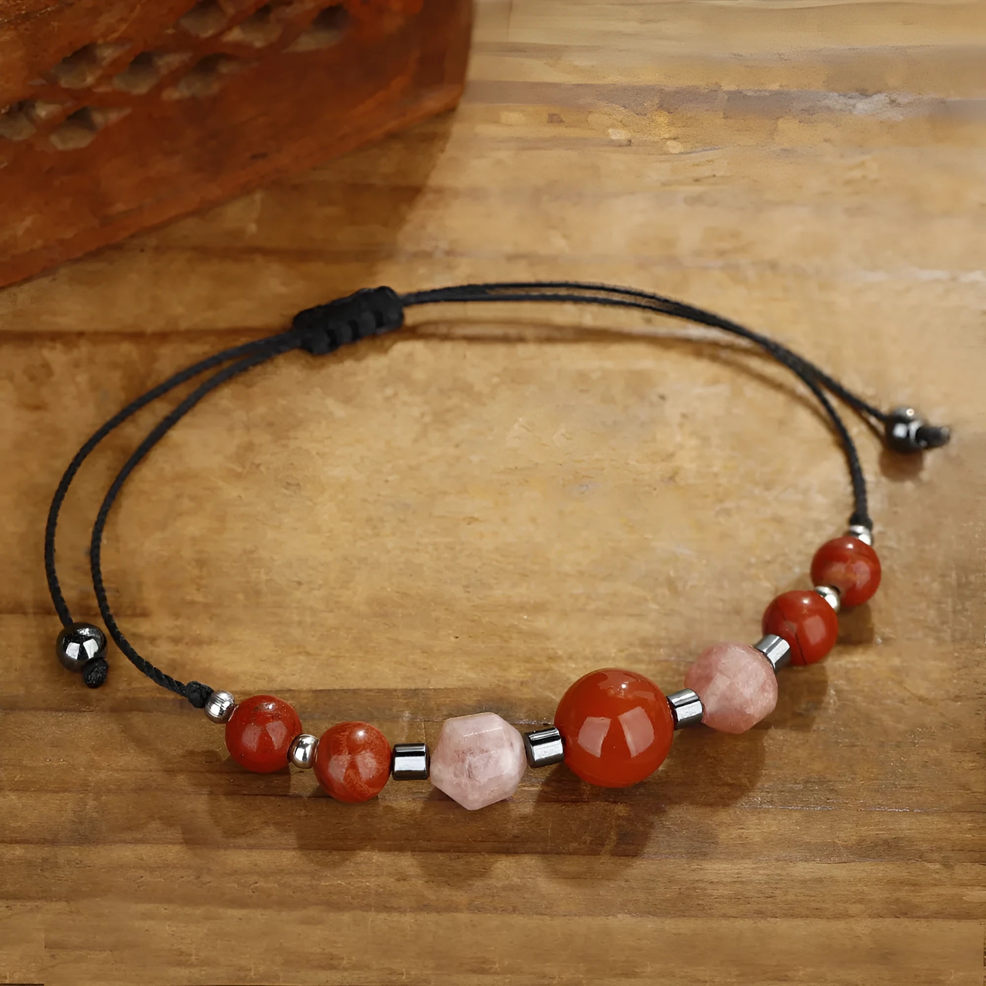 Handmade red geometric bracelet with sunstone, redstone, and copper beads.