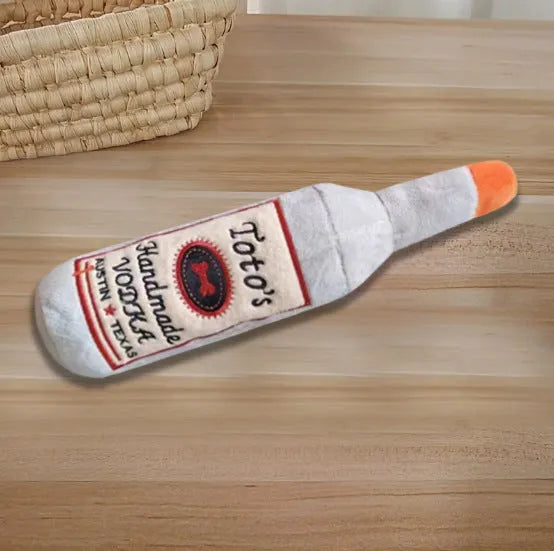Brown plush wine bottle shaped dog toy with molar detailing for chewing