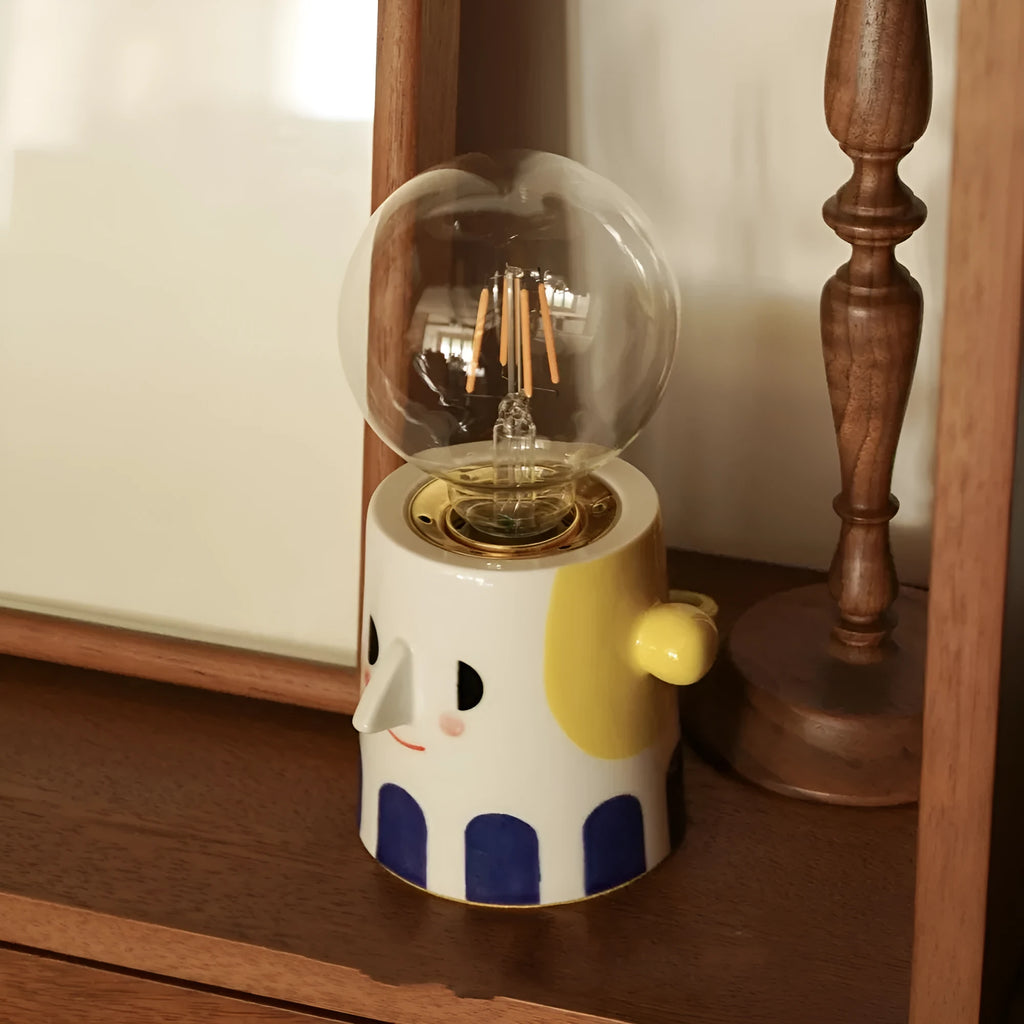 Handmade solid ceramic table lamp with a white spherical headlight shade on a bedside table.