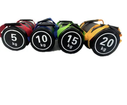 Flat white PVC fitness sandbag on gym floor, showing size and sturdy handles for weight training.