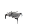 Black portable outdoor dog bed with removable washable cover and steel frame, shown on grass.