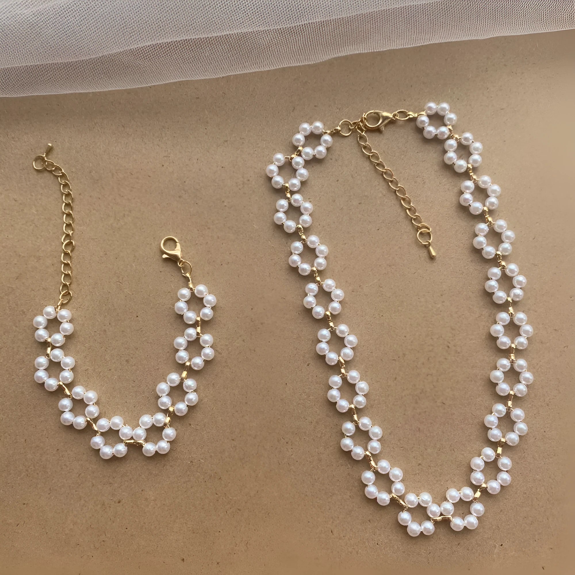 Pearl necklace and bracelet set for women on white background