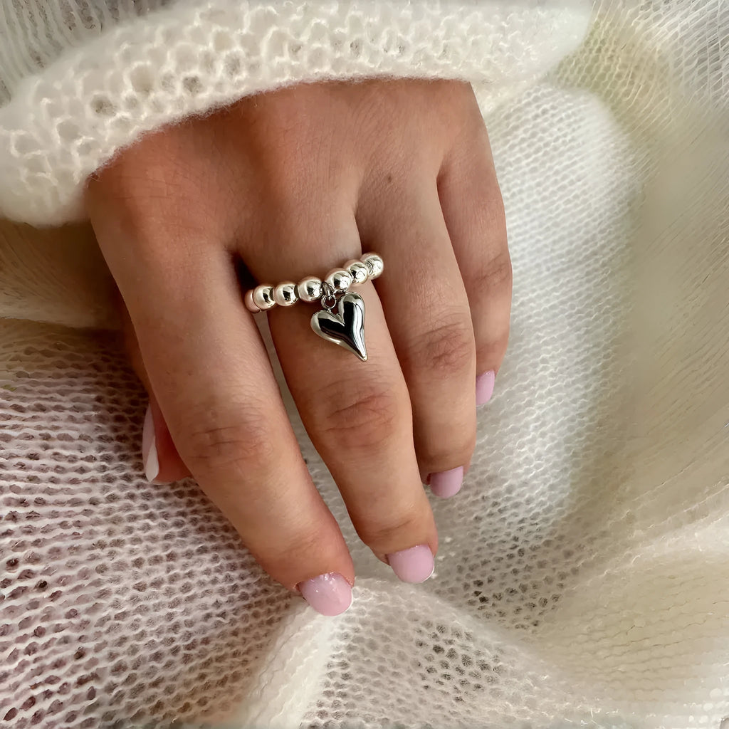 Handmade elastic beaded love ring with geometric heart design in gold and white electroplated finishes