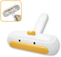 Portable pet hair remover with yellow duck design and removable lid on a fabric sofa.